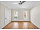 Bright bedroom features hardwood flooring, ceiling fan, and natural light from two windows at 40 Farrells Creek Rd, Apex, NC 27523