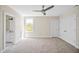 Bright bedroom with a ceiling fan, natural light, and neutral carpet at 40 Farrells Creek Rd, Apex, NC 27523