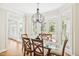 Bright dining area with glass top table, French doors and a view of the outdoor living area at 40 Farrells Creek Rd, Apex, NC 27523