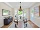 Elegant dining room featuring a chandelier, bay window, and stylish decor and ample natural light at 40 Farrells Creek Rd, Apex, NC 27523