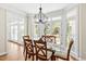 Bright dining area with glass top table, French doors and a view of the outdoor living area at 40 Farrells Creek Rd, Apex, NC 27523