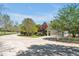 Long concrete driveway leading to a beautiful home with well-manicured lawns and mature trees at 40 Farrells Creek Rd, Apex, NC 27523