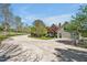 Long concrete driveway leading to a beautiful home with well-manicured lawns and mature trees at 40 Farrells Creek Rd, Apex, NC 27523