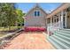 Charming home exterior with brick patio, flowering plants, and steps leading to a covered porch at 40 Farrells Creek Rd, Apex, NC 27523