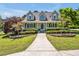 Inviting home with a cozy front porch, enhanced by beautiful landscaping and vibrant flower arrangements at 40 Farrells Creek Rd, Apex, NC 27523