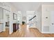 Spacious foyer with hardwood floors, stairs, and view into other rooms in the house at 40 Farrells Creek Rd, Apex, NC 27523