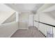 Hallway with neutral carpet, white trim, and a stair railing at 40 Farrells Creek Rd, Apex, NC 27523