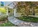 Home exterior featuring a green door and lush landscaping with trees and a sidewalk at 40 Farrells Creek Rd, Apex, NC 27523