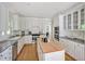 Bright, white kitchen with an island, modern appliances, and plenty of cabinet space for storage at 40 Farrells Creek Rd, Apex, NC 27523