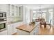 Open concept kitchen and breakfast area with island with breakfast bar and stainless steel appliances at 40 Farrells Creek Rd, Apex, NC 27523