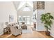 Bright living room with a stone fireplace, vaulted ceilings, and doors to the outside at 40 Farrells Creek Rd, Apex, NC 27523