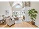 This bright living room boasts a stone fireplace, vaulted ceilings, and doors to the outside at 40 Farrells Creek Rd, Apex, NC 27523