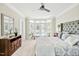 Bright main bedroom with carpet flooring, ceiling fan, and sitting area by french doors at 40 Farrells Creek Rd, Apex, NC 27523