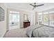 Bright main bedroom with carpet flooring, ceiling fan, and ensuite bathroom with soaking tub at 40 Farrells Creek Rd, Apex, NC 27523