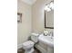 Powder room features a pedestal sink, tile flooring, decorative lighting and neutral walls at 40 Farrells Creek Rd, Apex, NC 27523