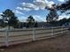 Spacious fenced property with a large grassy area, trees, and a visible basketball hoop at 40 Farrells Creek Rd, Apex, NC 27523