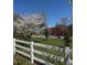 Picturesque yard with a white fence, a blooming cherry tree, and a tranquil country setting at 40 Farrells Creek Rd, Apex, NC 27523
