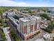 An aerial view of a high rise building with red awnings and lush green landscaping at 400 W North St # 1420, Raleigh, NC 27603