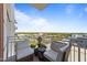 Relax on this condo balcony with charming chairs and enjoy the views of the surrounding cityscape and beautiful blue sky at 400 W North St # 1420, Raleigh, NC 27603