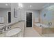 Bathroom features double sinks, a granite countertop, a soaking tub and a glass enclosed shower at 400 W North St # 1420, Raleigh, NC 27603