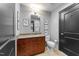Bathroom with granite counters, wood cabinets, modern fixtures, and contemporary decor at 400 W North St # 1420, Raleigh, NC 27603