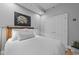 A comfortable bedroom featuring an art piece, recessed lighting, and a white double door at 400 W North St # 1420, Raleigh, NC 27603