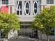 Elegant building entrance with modern architectural details, green trees, and prominent numbering at 400 W North St # 1420, Raleigh, NC 27603