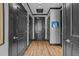 Hallway with hardwood floors, black doors, black trim, and stylish wall art at 400 W North St # 1420, Raleigh, NC 27603