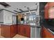 Spacious kitchen featuring granite countertops, wood cabinets, and stainless steel appliances at 400 W North St # 1420, Raleigh, NC 27603