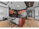 Kitchen island with modern lighting fixtures, granite counters, and stainless steel appliances at 400 W North St # 1420, Raleigh, NC 27603