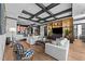 Cozy living room with open concept to the kitchen and hardwood floors beneath the coffered ceilings at 400 W North St # 1420, Raleigh, NC 27603