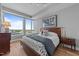 This bright primary bedroom has hardwood floors, a modern design, and a large window with wonderful city views at 400 W North St # 1420, Raleigh, NC 27603