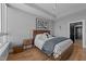 Bright primary bedroom featuring hardwood floors, modern furniture, and large windows for an abundance of natural light at 400 W North St # 1420, Raleigh, NC 27603