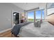 Bedroom featuring a large window with treetop views and an ensuite bath at 400 W North St # 1420, Raleigh, NC 27603