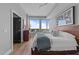 Bright primary bedroom with hardwood floors, a large window with great city views, and a comfortable, modern bed at 400 W North St # 1420, Raleigh, NC 27603