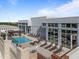 Relax by the rooftop pool with chairs and outdoor dining area with lush green scenic views at 400 W North St # 1420, Raleigh, NC 27603
