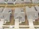 An aerial view of homes in a residential neighborhood with similar architectural design and landscaping at 421 Raven Cliff St, Apex, NC 27523