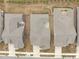 A bird's-eye view of several homes, showcasing their roofs, driveways, and fenced yards at 421 Raven Cliff St, Apex, NC 27523
