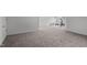 Spacious basement featuring neutral carpet, white trim, and access to storage at 421 Raven Cliff St, Apex, NC 27523