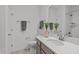 Well-lit bathroom featuring a single vanity, quartz countertops, and walk-in shower at 421 Raven Cliff St, Apex, NC 27523