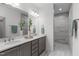 Bathroom featuring double vanity with quartz countertops, modern fixtures, and tiled walk-in shower at 421 Raven Cliff St, Apex, NC 27523