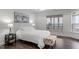 Serene bedroom featuring stylish decor, hardwood floors, and abundant natural light at 421 Raven Cliff St, Apex, NC 27523