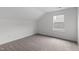 Bedroom featuring neutral carpet, white trim, and a window with natural light at 421 Raven Cliff St, Apex, NC 27523