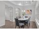Dining room featuring a white marble dining table and convenient access to the kitchen and living area at 421 Raven Cliff St, Apex, NC 27523