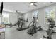 Well-lit gym with ceiling fans and large windows featuring cardio equipment for a healthy lifestyle at 421 Raven Cliff St, Apex, NC 27523