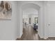 Elegant hallway with arched entryway, leading to an open floor plan with hardwood floors and neutral walls at 421 Raven Cliff St, Apex, NC 27523