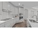 Bright, stylish kitchen featuring white cabinets, quartz countertops, and modern stainless steel appliances at 421 Raven Cliff St, Apex, NC 27523