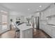 Modern kitchen overlooking a spacious living room with a fireplace, perfect for entertaining guests at 421 Raven Cliff St, Apex, NC 27523