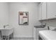 Well-equipped laundry room with white cabinets, utility sink, and modern washer and dryer at 421 Raven Cliff St, Apex, NC 27523