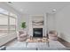 Bright living room featuring a fireplace, plush seating, and recessed lighting at 421 Raven Cliff St, Apex, NC 27523